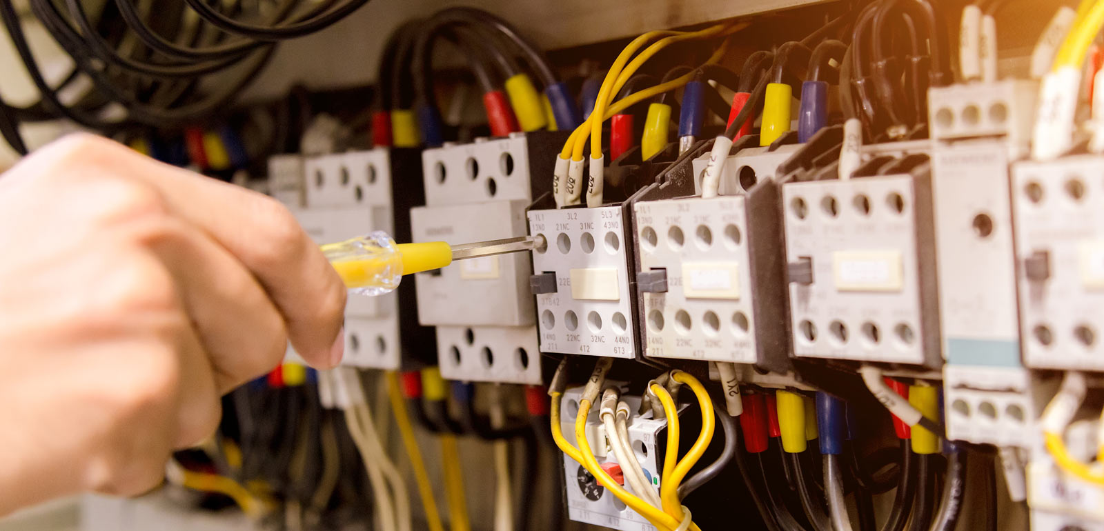 Hands working on electrical wiring